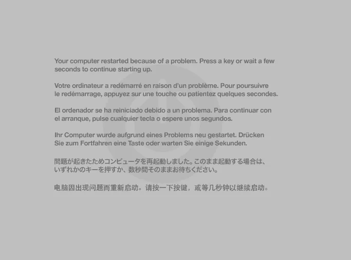 Schermata grigia di kernel panic che invita a riavviare il computer, in piu' lingue