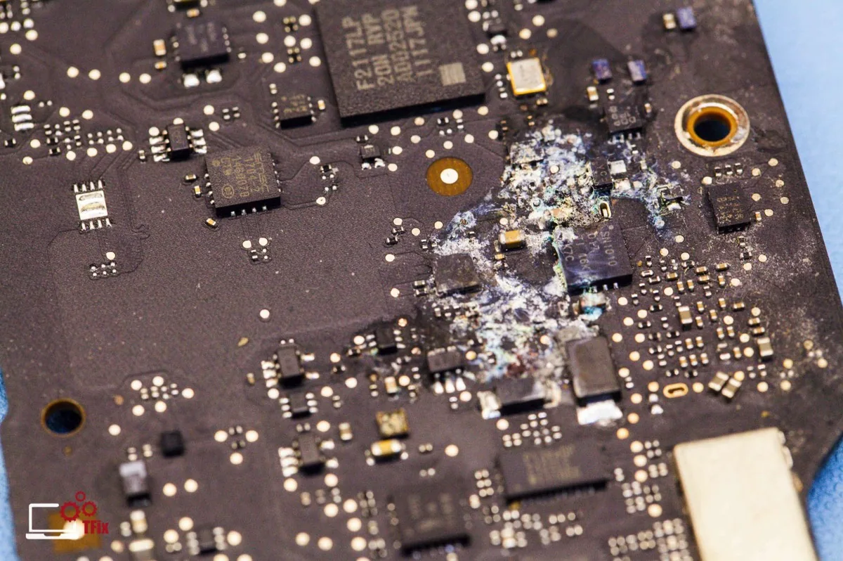 Scheda logica di un Mac con tracce di ossido e componenti corrosi da un danno da liquido
